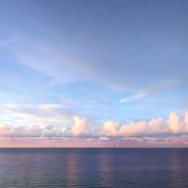 Calm ocean with fluffy clouds