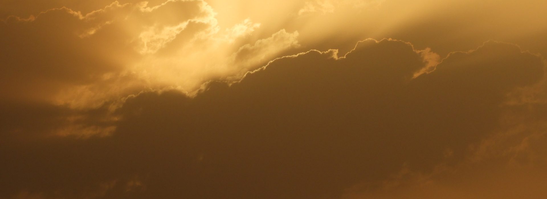 Clouds with golden sun rays